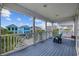 A charming balcony offers seating and a beautiful view of neighborhood at 22 Ocean Blvd. N, Surfside Beach, SC 29575