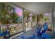 Comfortable porch offers seating and a view of palm trees and neighborhood at dusk at 22 Ocean Blvd. N, Surfside Beach, SC 29575