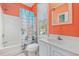 Orange bathroom with a shower-tub combo, a white vanity, and beach-themed decor at 22 Ocean Blvd. N, Surfside Beach, SC 29575