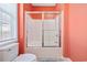 Bathroom featuring a sliding glass shower door, window, and toilet at 22 Ocean Blvd. N, Surfside Beach, SC 29575
