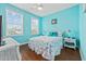 Bright bedroom with wood floors, ceiling fan, and light blue walls at 22 Ocean Blvd. N, Surfside Beach, SC 29575