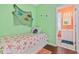 Bright bedroom with a green accent wall, single bed, and view into the adjacent bathroom at 22 Ocean Blvd. N, Surfside Beach, SC 29575