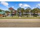 Charming colorful homes with white picket fences, palm trees, and stairs leading to covered porches at 22 Ocean Blvd. N, Surfside Beach, SC 29575