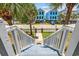 Staircase view to colorful homes with white picket fences and palm trees, highlighting curb appeal at 22 Ocean Blvd. N, Surfside Beach, SC 29575