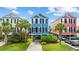 Two-story colorful home with black shutters, palm trees, driveway, and lush landscaping at 22 Ocean Blvd. N, Surfside Beach, SC 29575