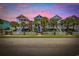 Charming colorful homes with white picket fences, palm trees, and stairs leading to covered porches at 22 Ocean Blvd. N, Surfside Beach, SC 29575