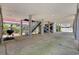 Garage with concrete pillars, grill, wooden stairs, and door to home at 22 Ocean Blvd. N, Surfside Beach, SC 29575
