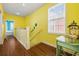 Well-lit hallway with wood floors and a window overlooking the outside at 22 Ocean Blvd. N, Surfside Beach, SC 29575