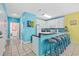 Kitchen featuring breakfast bar, white cabinets, and access to a full bathroom at 22 Ocean Blvd. N, Surfside Beach, SC 29575