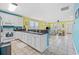 Open concept kitchen and living room, white cabinetry, and tile flooring throughout at 22 Ocean Blvd. N, Surfside Beach, SC 29575