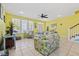 Spacious living room with tile flooring, yellow walls, and plenty of natural light from large windows at 22 Ocean Blvd. N, Surfside Beach, SC 29575