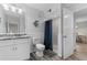 Well-lit bathroom features a vanity with marble countertops, shower, and decorative fish art at 223 Maison Dr. # 14D, Myrtle Beach, SC 29572