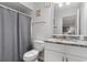 Neutral bathroom features granite counters and shower with gray curtain at 223 Maison Dr. # 14D, Myrtle Beach, SC 29572