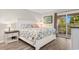 Inviting bedroom features a queen-size bed, starfish themed bedspread and sliding glass door to patio at 223 Maison Dr. # 14D, Myrtle Beach, SC 29572