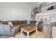 Bright living room area with gray sofa, patterned pillows, a wooden coffee table and a spiral staircase at 223 Maison Dr. # 14D, Myrtle Beach, SC 29572