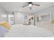 Bright bedroom boasts ceiling fan, hardwood floors, walk-in closet, and ensuite bathroom at 223 Maison Dr. # C-13, Myrtle Beach, SC 29572