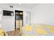 Bedroom with hardwood floors, ceiling fan, large closet, and a television at 223 Maison Dr. # C-13, Myrtle Beach, SC 29572