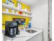 Bright coffee station with marble counters, shelving, sink, and coffee maker is a perfect addition to any kitchen at 223 Maison Dr. # C-13, Myrtle Beach, SC 29572