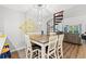 Cozy dining area with a wooden table, chairs, hanging lights, and a spiral staircase at 223 Maison Dr. # C-13, Myrtle Beach, SC 29572