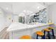 Bright kitchen with modern countertops, seating, stainless appliances, backsplash and an adjacent laundry area at 223 Maison Dr. # C-13, Myrtle Beach, SC 29572