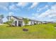View of the backyard featuring a well-manicured lawn and screened in patio with landscaping at 2352 Elowen Ln. # 22B, Longs, SC 29568