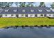 Aerial view of home's backyard, displaying lush lawn and pond adding natural beauty to the property at 2352 Elowen Ln. # 22B, Longs, SC 29568