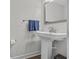 Bathroom featuring a pedestal sink, a stylish mirror, and fresh blue towels at 2352 Elowen Ln. # 22B, Longs, SC 29568