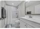 Bright bathroom with white vanity, shower-tub combo with white shower curtain, and neutral-toned tile at 2352 Elowen Ln. # 22B, Longs, SC 29568