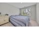 Cozy bedroom with a blue and white striped bedspread, dresser, and a window view at 2352 Elowen Ln. # 22B, Longs, SC 29568