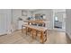Inviting dining space with a rustic wooden table, bench seating, and stylish decor at 2352 Elowen Ln. # 22B, Longs, SC 29568