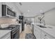 Bright kitchen featuring stainless steel appliances, white cabinetry, and open layout to the dining area at 2352 Elowen Ln. # 22B, Longs, SC 29568