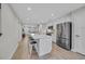 Contemporary open-concept kitchen with an island, stainless steel appliances, and adjacent living area, perfect for entertaining at 2352 Elowen Ln. # 22B, Longs, SC 29568