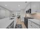 Modern kitchen design with white cabinets, stainless steel appliances, and a large island overlooking the living area at 2352 Elowen Ln. # 22B, Longs, SC 29568