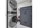Well-equipped laundry room featuring a stacked washer/dryer and a secure safe, offering convenience and peace of mind at 2352 Elowen Ln. # 22B, Longs, SC 29568