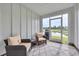 The enclosed sunroom has two plush chairs, a ceiling fan, and a view of the water and outdoors at 2352 Elowen Ln. # 22B, Longs, SC 29568