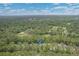 Aerial view of a home nestled in a lush, green wooded area, showcasing its serene location at 24 Gate 7, Carolina Shores, NC 28467