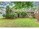 Spacious backyard featuring an outdoor patio, mature trees, and a well-kept lawn at 24 Gate 7, Carolina Shores, NC 28467