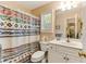 Cozy bathroom with a patterned shower curtain and white vanity at 24 Gate 7, Carolina Shores, NC 28467
