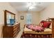 Charming bedroom with a large dresser, window shutters, and a floral quilt at 24 Gate 7, Carolina Shores, NC 28467