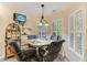 Cozy breakfast nook with window seating, pendant lighting, and a view to a wall mounted TV at 24 Gate 7, Carolina Shores, NC 28467