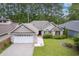 Attractive single-Gathering home with well-manicured lawn, brick accents, and an attached garage at 24 Gate 7, Carolina Shores, NC 28467