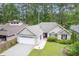 Beautiful home with brick accents, manicured lawn, and an attached two-car garage at 24 Gate 7, Carolina Shores, NC 28467