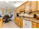 Bright kitchen featuring oak cabinets, a breakfast nook, and tile flooring at 24 Gate 7, Carolina Shores, NC 28467