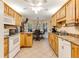 Traditional eat-in kitchen features tile floors, oak cabinets, and white appliances at 24 Gate 7, Carolina Shores, NC 28467