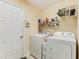 Practical laundry room with a washer, dryer, and storage shelving at 24 Gate 7, Carolina Shores, NC 28467