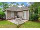 Charming outdoor patio space with furniture and a white picket fence, ideal for relaxation at 24 Gate 7, Carolina Shores, NC 28467