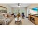 Relaxing sitting room with plush sofa, plantation shutters and a view to a television at 24 Gate 7, Carolina Shores, NC 28467