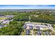 Aerial view of a commercial and residential area with trees surrounding a neighborhood at 309 Foxpath Loop, Myrtle Beach, SC 29588