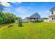 Expansive backyard features a pond, gazebo with outdoor seating, and well-maintained green space at 309 Foxpath Loop, Myrtle Beach, SC 29588