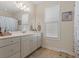 Well-lit bathroom vanity with a large mirror and neutral decor at 309 Foxpath Loop, Myrtle Beach, SC 29588